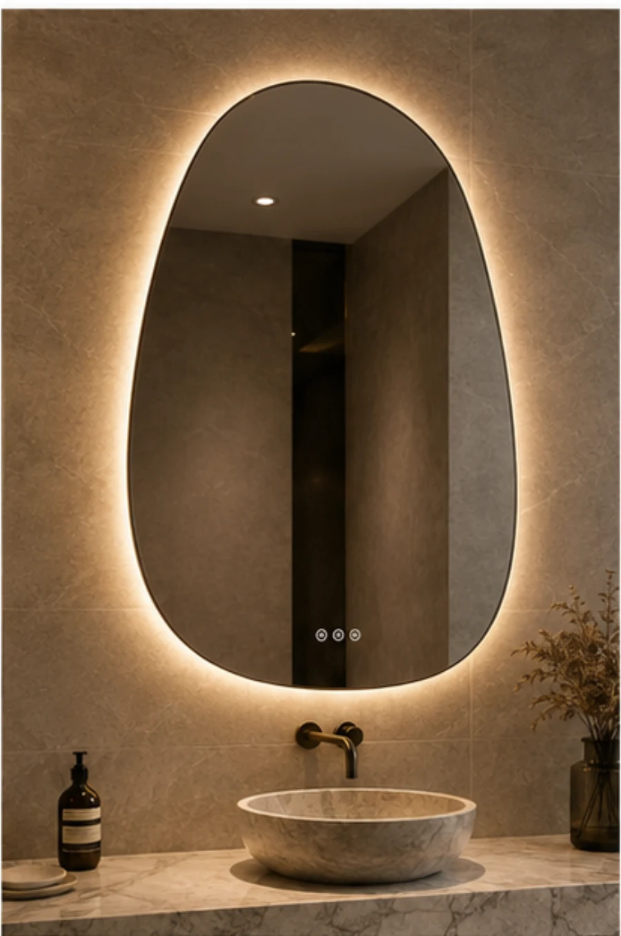 Warm backlit asymmetrical LED mirror above a bathroom vanity