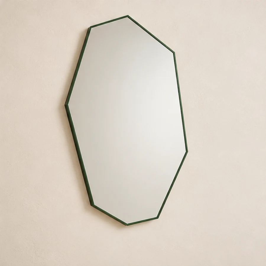 Faceted angular geometric mirror with a dark green frame