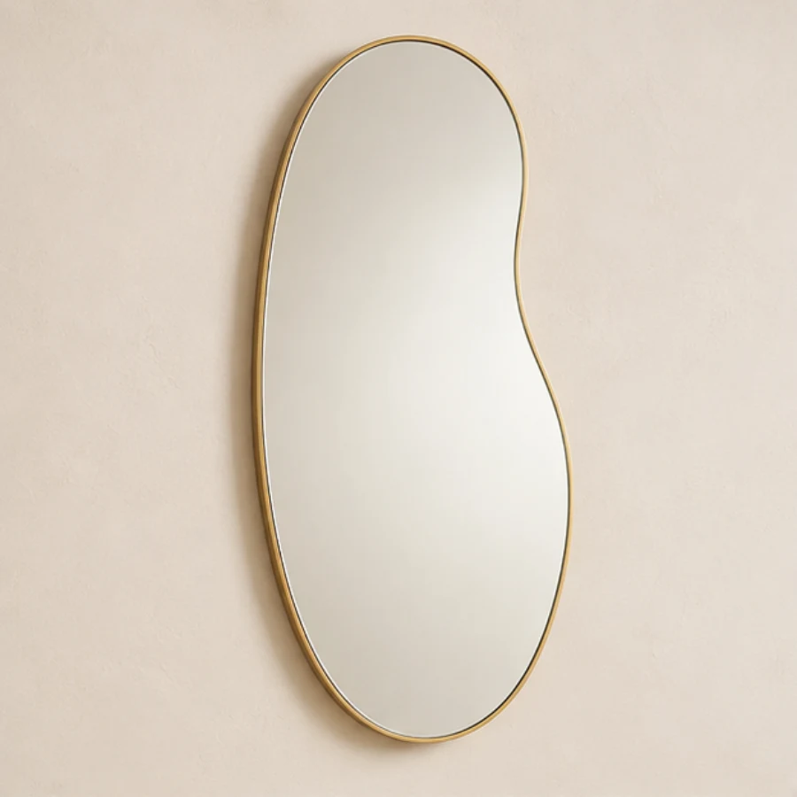 Tall organic freeform mirror with a slim champagne edge