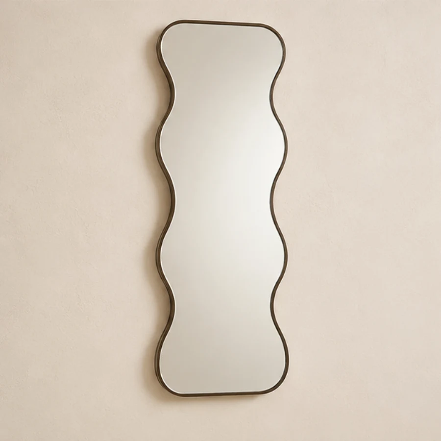 Vertical wavy profile mirror with a brushed bronze frame
