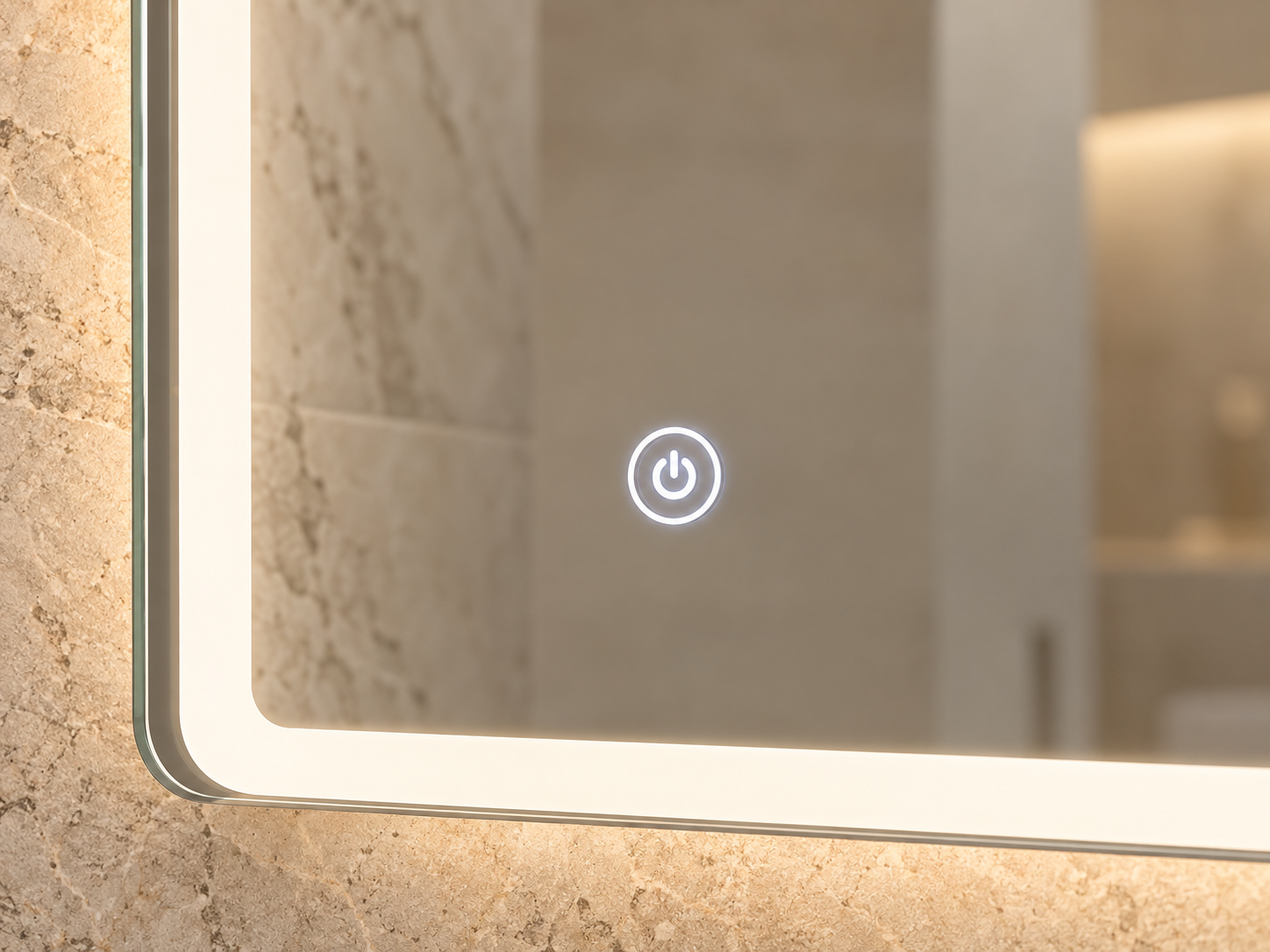 Close-up of a circular illuminated power touch button integrated flush into an LED bathroom mirror