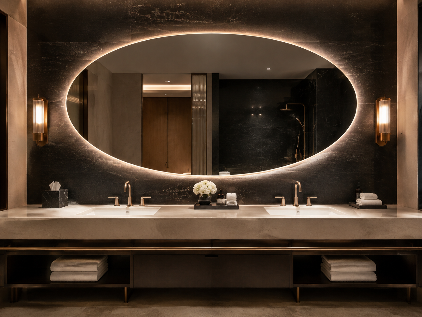 Oversized horizontal oval mirror above a hotel double vanity