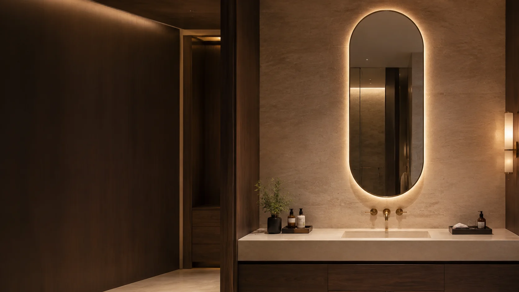 Backlit pill shaped mirror in a high-end hospitality bathroom