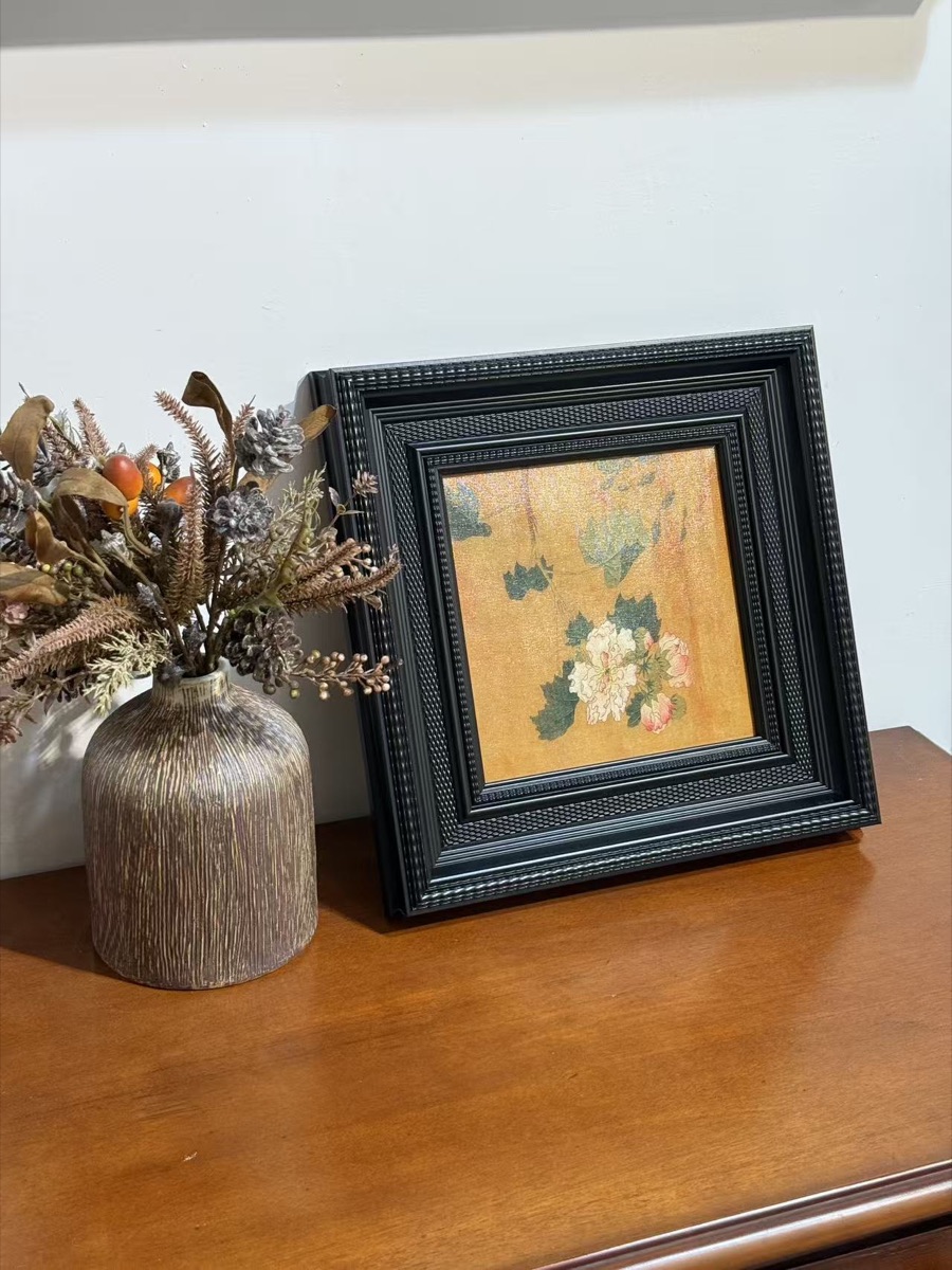 Layered black decorative frame assembly