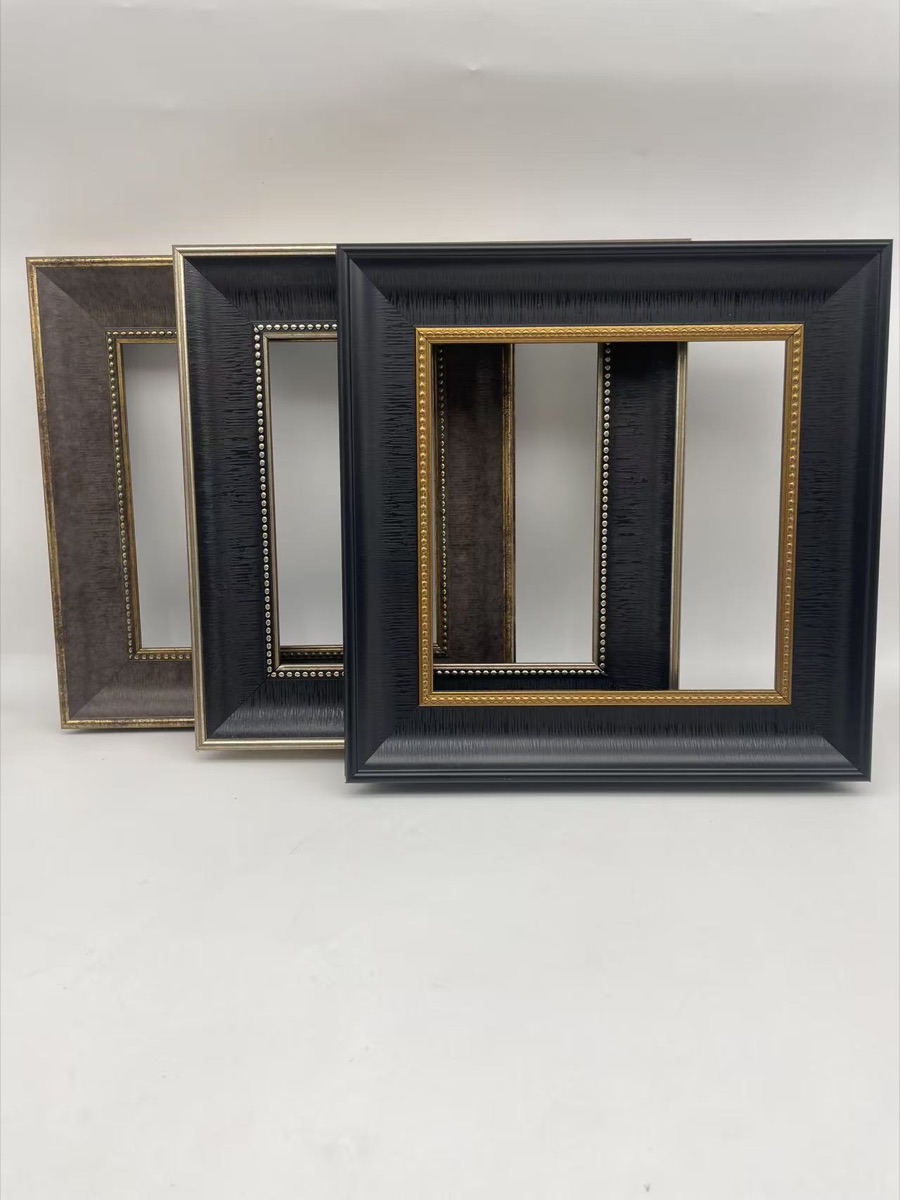 Physical wide charcoal black frame samples with gold inner trim
