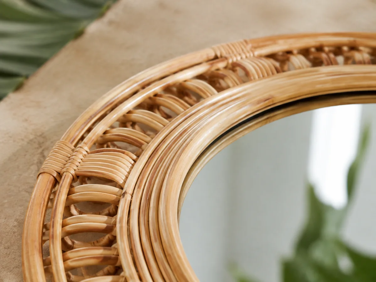 Close view of woven natural rattan, wrapped joints and the mirror glass edge
