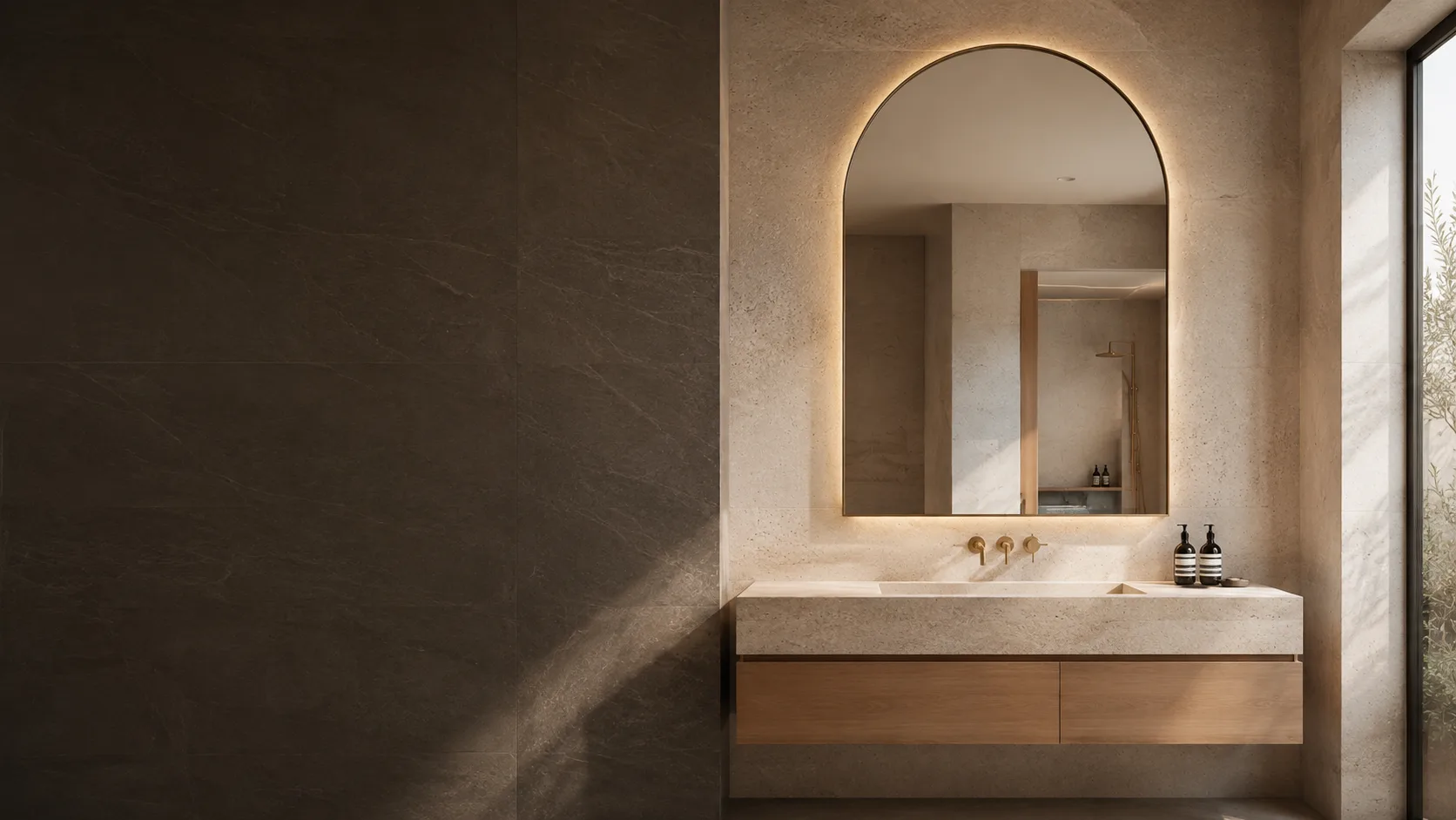 Custom arched illuminated bathroom vanity mirror in a hotel bathroom